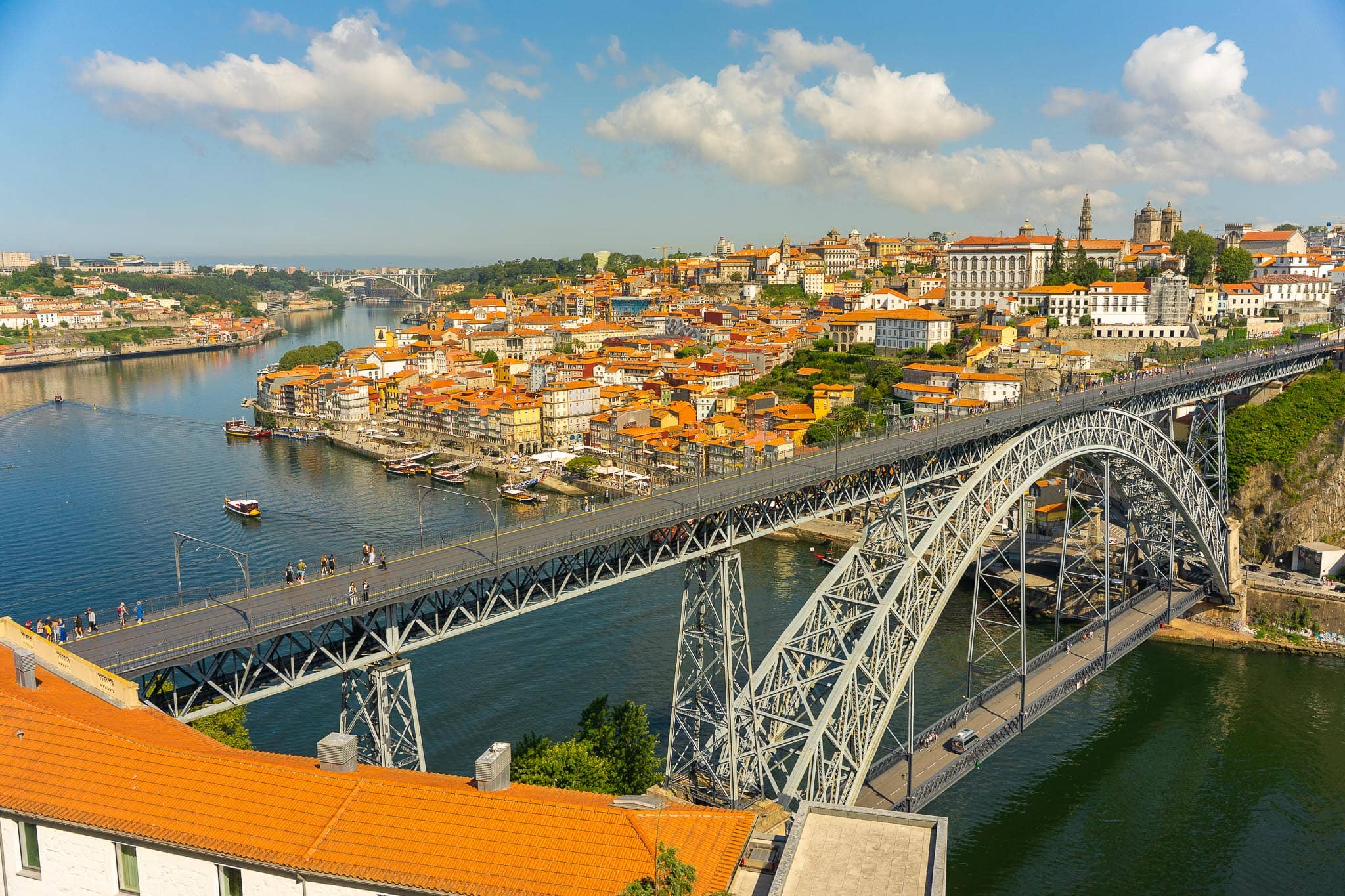 The double-deck iron arch of the Ponte Dom Luis I spanning the Douro at Porto, with the tiled roofs of the old city climbing the far bank.